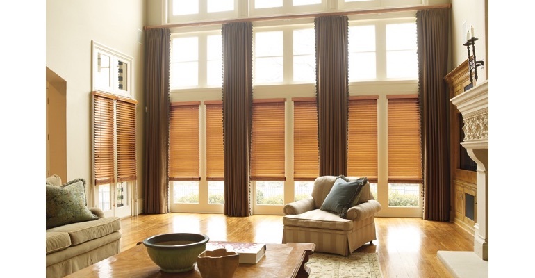 Salt Lake City great room with wooden blinds and full-length draperies.